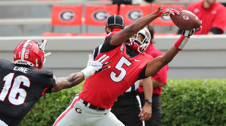 Georgia wide receiver Adonai Mitchell catches a touchdown pass past defensive back Lewis Cine during the final drive of the second quarter in the G-Day Game Saturday, April 17, 2021, at Sanford Stadium in Athens. (Curtis Compton / Curtis.Compton@ajc.com)