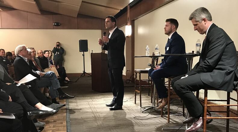 Three candidates vying for the Democratic nomination for Georgia’s Sixth Congressional District — Kevin Abel, standing left, Bobby Kaple, seated right, and Steven Griffin, seated middle — sounded off about gun safety at a forum Monday in Sandy Springs. JEREMY REDMON/jredmon@ajc.com