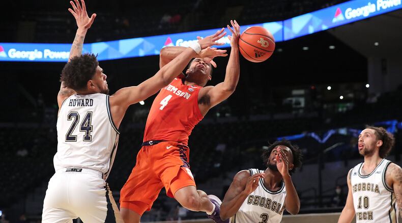 012021 Atlanta: Georgia Tech center Rodney Howard forces a loose ball defending against Clemson guard Nick Honor in an NCAA college basketball game on Tuesday, Jan. 20, 2021, in Atlanta. Georgia Tech upset Clemson 83-65. Curtis Compton / Curtis.Compton@ajc.com���