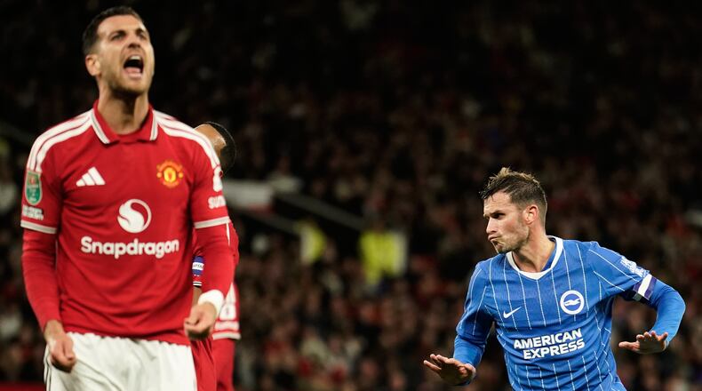 Brighton's Pascal Gross, right, celebrates after scoring his side's second goal during the English League Cup third round soccer match between Manchester United and Brighton and Hove Albion in Manchester, England, Wednesday, Sept. 16, 2026. (AP Photo/Dave Thompson)