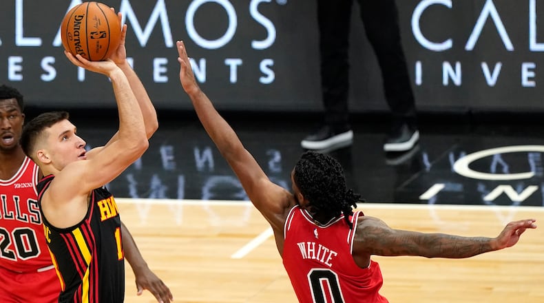 Atlanta Hawks guard Bogdan Bogdanovic shoots as Chicago Bulls guard Coby White (right) defends during the second half Wednesday, Dec. 23, 2020, in Chicago. (Nam Y. Huh/AP)