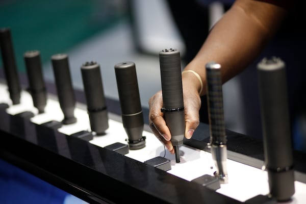 FILE- Gun silencers are on display at the Sig Sauer booth at the Shooting, Hunting and Outdoor Trade Show in Las Vegas, Jan. 19, 2016. (AP Photo/John Locher, File)