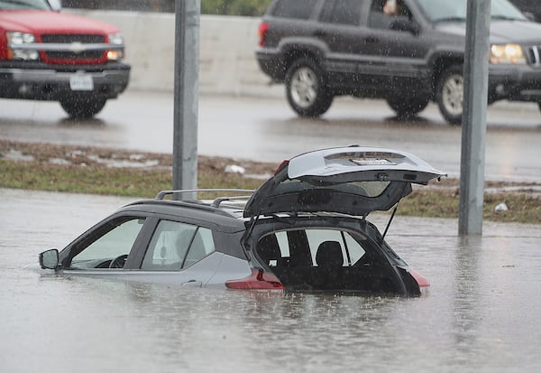 A strand vehicle is left on frontage road in front the McAllen Convention Center during a downpour on Thursday, March 27, 2025, in McAllen., Texas. (Joel Martinez /The Monitor via AP)