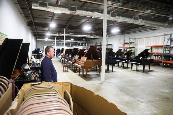 David England stands in the half-empty warehouse at England Piano. He had hoped to hand the store off to his son. (Abbey Cutrer/AJC)