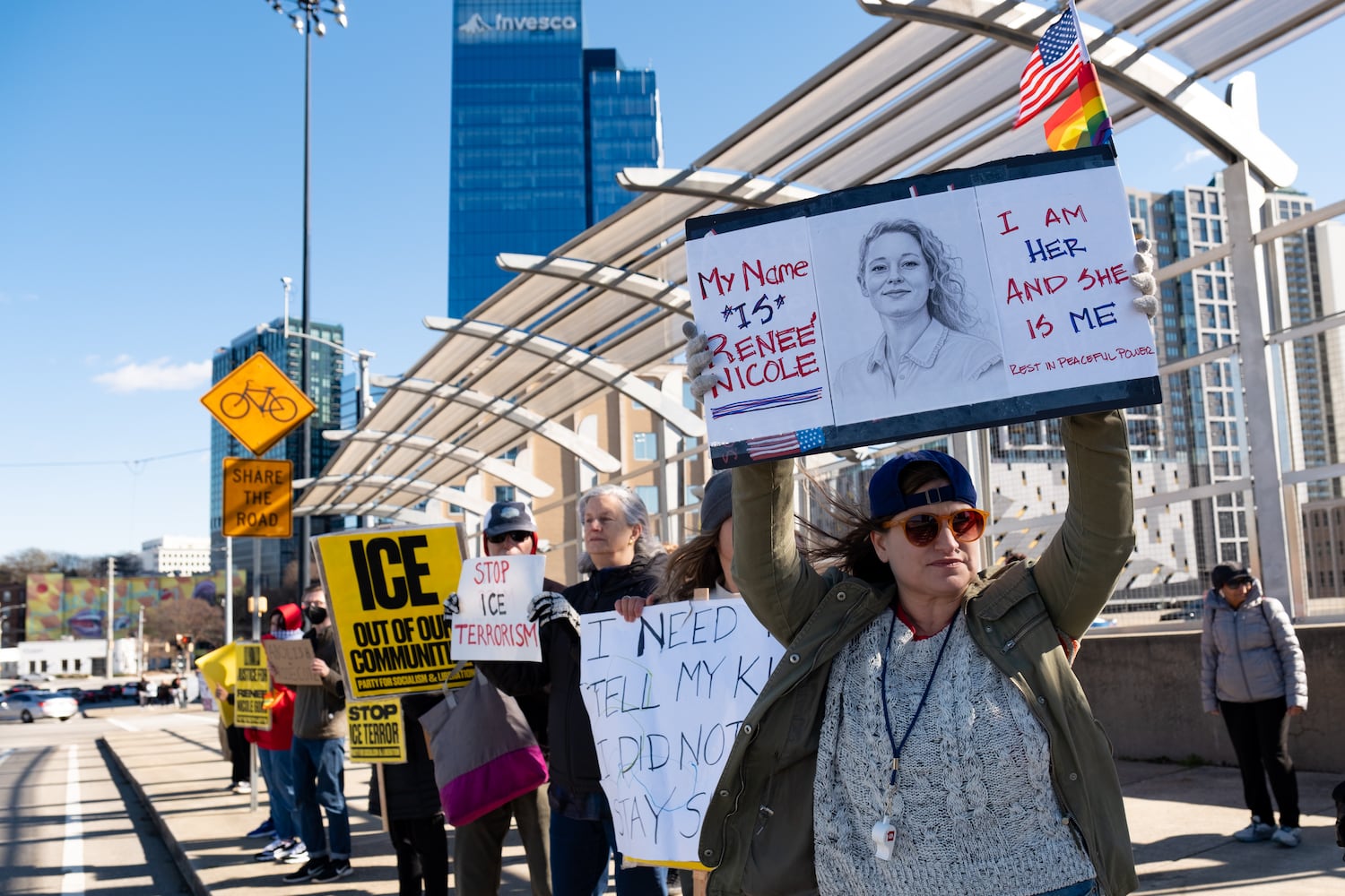 A woman who shares the name Reneé Nicolejoins others on the 17th Street Bridge in Atlanta on Sunday, Jan. 11, 2026 to protest the ICE shooting of Renee Good and the US military action in Venezuela. Ben Gray for the Atlanta Journal-Constitution
