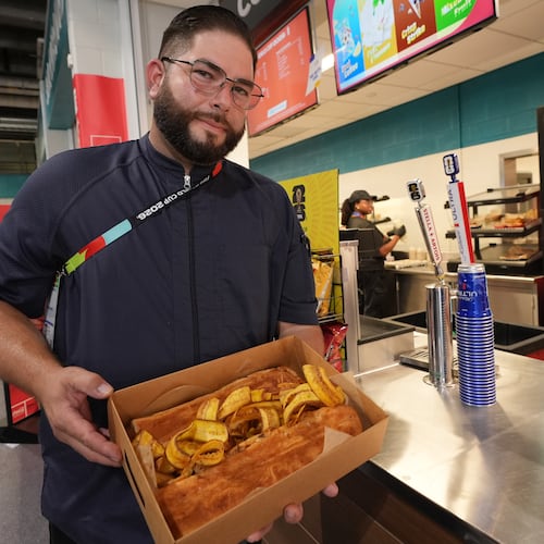 Lazaro Luya, the concession chef at Sol Cubano, displays their special, pan with lechon and fresh mariquitas at Miami Stadium Sunday, June 21, 2026, in Miami Gardens, Fla. (AP Photo/Marta Lavandier)