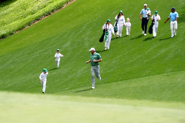 040622 Augusta:  Jason Kokrak runs down the fairway with his sons during the Par 3 Contest of the Masters at Augusta National Golf Club on Wednesday, April 6, 2022, in Augusta. “Curtis Compton / Curtis.Compton@ajc.com”