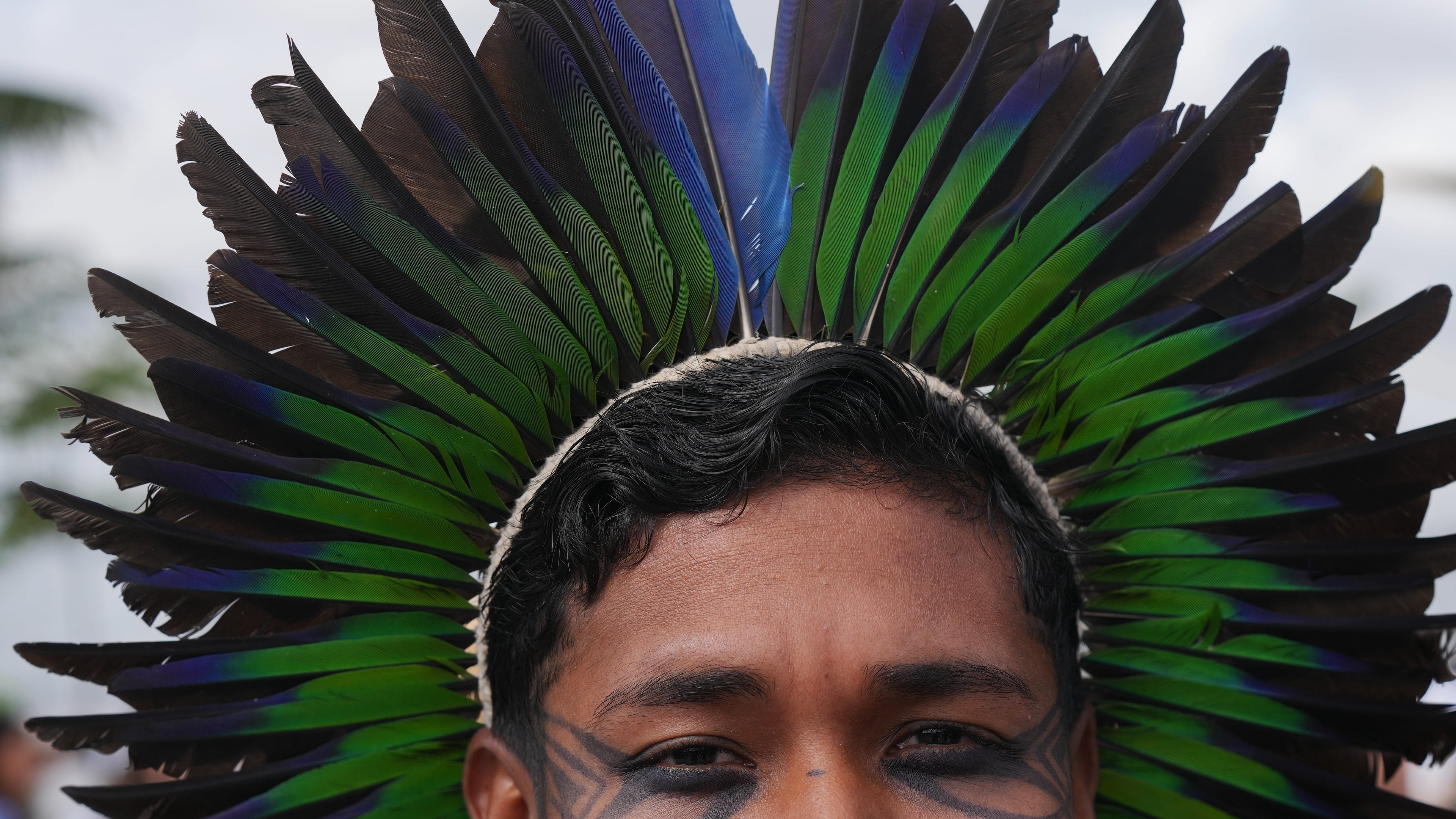 Hamangui, a Brazilian Indigenous activist, poses for a photo outside the venue for the COP30 U.N. Climate Summit, Tuesday, Nov. 11, 2025, in Belem, Brazil. (AP Photo/Fernando Llano)