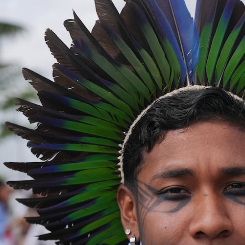 Hamangui, a Brazilian Indigenous activist, poses for a photo outside the venue for the COP30 U.N. Climate Summit, Tuesday, Nov. 11, 2025, in Belem, Brazil. (AP Photo/Fernando Llano)