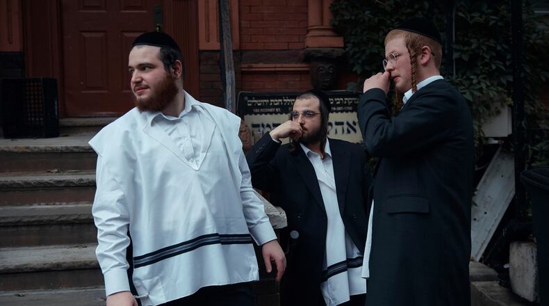 FILE - Hasidic Jewish men chat on June 16, 2025, in the Brooklyn borough of New York. (AP Photo/Andres Kudacki, File)