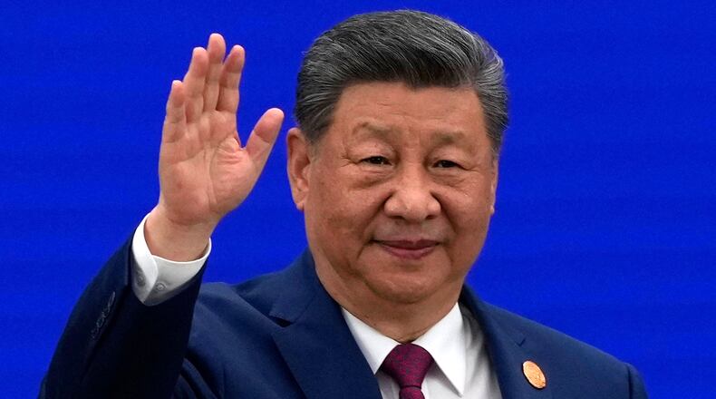 Chinese President Xi Jinping waves as he arrives at the opening ceremony for the World AI Conference in Shanghai, Friday, July 17, 2026. (AP Photo/Ng Han Guan, Pool)