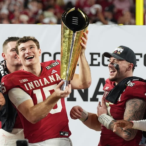 FILE - Indiana quarterback Fernando Mendoza holds the trophy after Indiana defeated Miami in a College Football Playoff national championship game in Miami Gardens, Fla., Jan. 19, 2026, (AP Photo/Lynne Sladky, File)