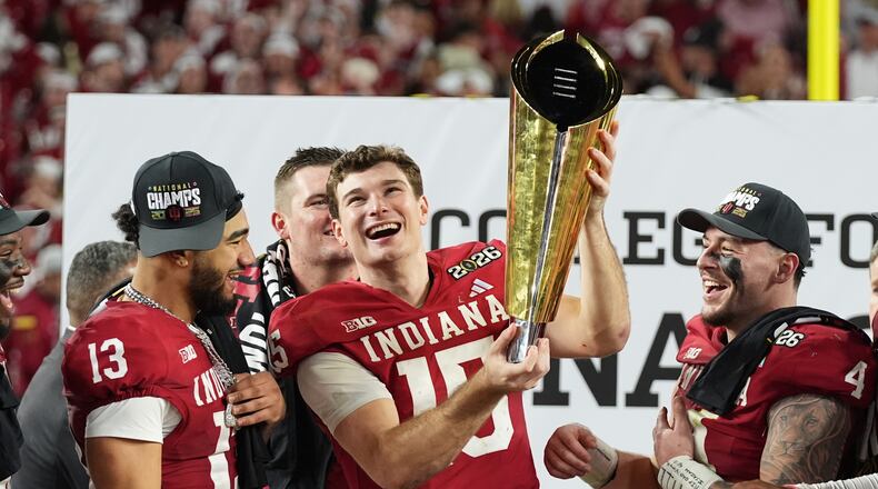 FILE - Indiana quarterback Fernando Mendoza holds the trophy after Indiana defeated Miami in a College Football Playoff national championship game in Miami Gardens, Fla., Jan. 19, 2026, (AP Photo/Lynne Sladky, File)