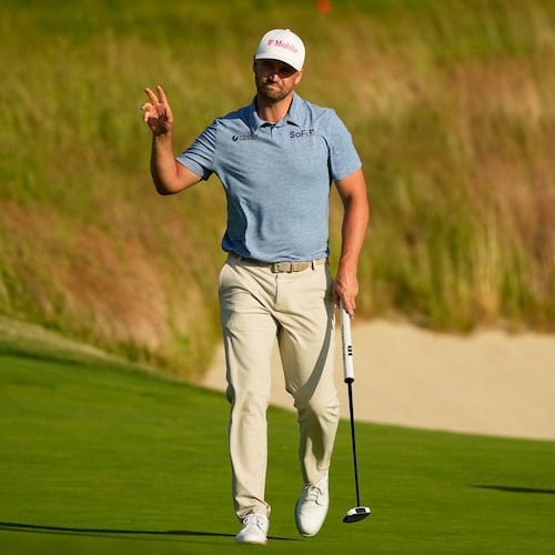 Wyndham Clark waves after his putt on the 18th hole during the first round of the U.S. Open golf tournament at Shinnecock Hills Golf Club in Southampton, N.Y., Thursday, June 18, 2026.(AP Photo/Gerald Herbert)