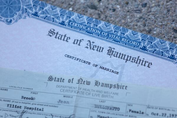 A marriage certificate and birth certificate are pictured and are among the paperwork required by Brooke Younge to register to vote in Derry, N.H., Tuesday, March 11, 2025. (AP Photo/Reba Saldanha)