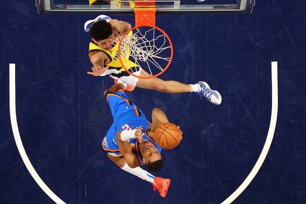 Oklahoma City Thunder guard Aaron Wiggins (21) attempts a shot against Indiana Pacers guard Ben Sheppard (26) during the second half of Game 6 of the NBA Finals basketball series, Thursday, June 19, 2025, in Indianapolis. (Maddie Meyer/Pool Photo via AP)