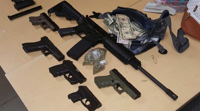 A search warrant was issued, which allowed the officers to recover five handguns and an AR-15 that police said was confirmed stolen out of Doraville. (Credit: Atlanta Police Department)