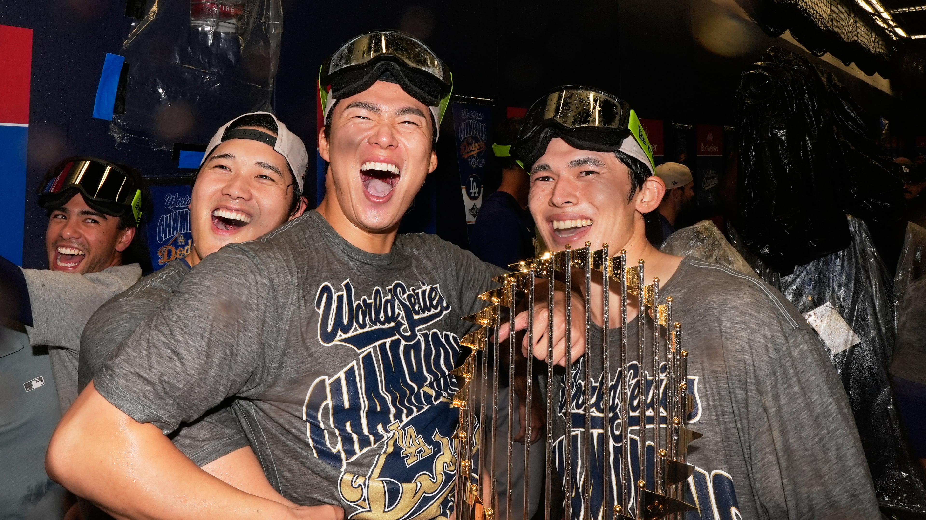 Los Angeles Dodgers pitcher Shohei Ohtani, pitcher Yoshinobu Yamamoto and pitcher Roki Sasaki celebrate after their win against the Toronto Blue Jays in Game 7 of baseball's World Series, Sunday, Nov. 2, 2025, in Toronto. (AP Photo/Brynn Anderson)