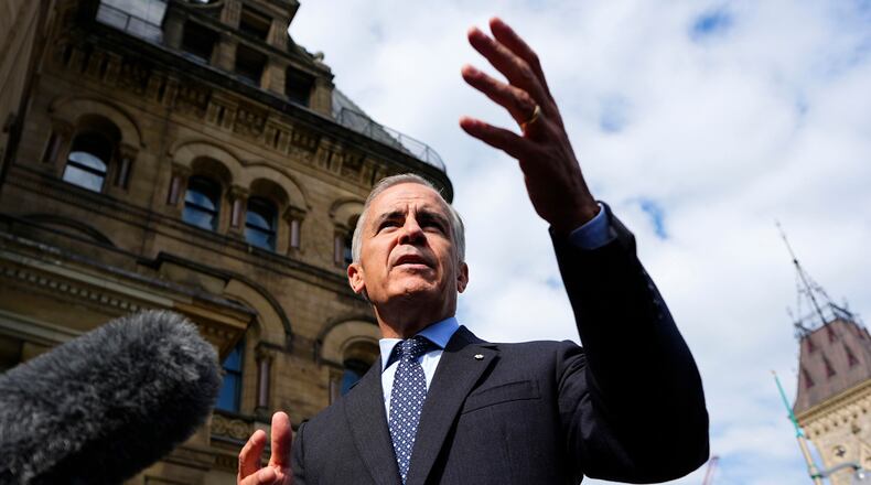 Prime Minister Mark Carney speaks to journalists as he arrives at the Office of the Prime Minister and Privy Council in Ottawa, on Tuesday, Sept. 1, 2026. (Justin Tang/The Canadian Press via AP)