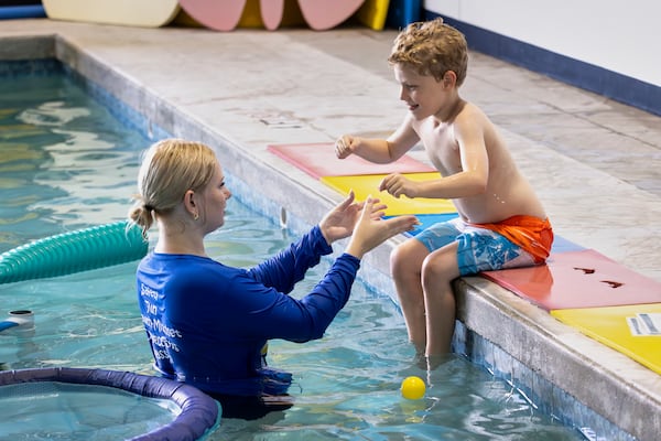 In this handout photo provided by Children's Services Council of Palm Beach County, aquatic educator Riley Taylor helps a student into the water during an autism-specific swim class at Small Fish Big Fish, Tuesday, April 1, 2025 in West Palm Beach, Fla. ((Ben Rusnak /Children's Services Council of Palm Beach County via AP)