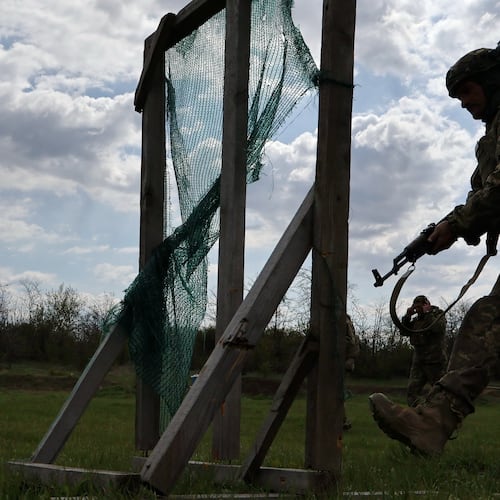 In this photo provided by Ukraine's 65th Mechanized Brigade press service, recruits practice military skills at a training ground near the frontline in the Zaporizhzhia region, Ukraine, Wednesday, April 29, 2026. (Andriy Andriyenko/Ukraine's 65th Mechanized Brigade via AP)