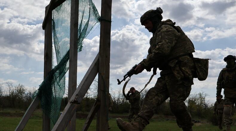 In this photo provided by Ukraine's 65th Mechanized Brigade press service, recruits practice military skills at a training ground near the frontline in the Zaporizhzhia region, Ukraine, Wednesday, April 29, 2026. (Andriy Andriyenko/Ukraine's 65th Mechanized Brigade via AP)