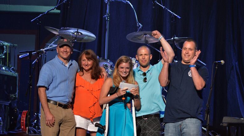 BOSTON, MA - MAY 30: Marathon bystander Bruce Mendhelson, first responder Alicia Shambo, Marathon victim Victoria McGrath, first responder Tyler Dodd, and Boston firefighter Jimmy Plourde on stage during the Boston Strong: An Evening Of Support And Celebration at TD Garden on May 30, 2013 in Boston, Massachusetts. (Photo by Paul Marotta/Getty Images)