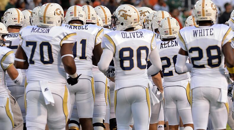 October 4, 2014 Atlanta - Georgia Tech Yellow Jackets players warm up before their game against the Miami Hurricanes at Bobby Dodd Stadium on Saturday, October 4, 2014. As Georgia colleges have become more selective in who they admit, they remain willing to bend the rules for football players. For the first time, the AJC has collected SAT scores of college football players in the state shows they trail other freshmen. HYOSUB SHIN / HSHIN@AJC.COM Georgia Tech started off the season 5-0. (Hyosub Shin / AJC)