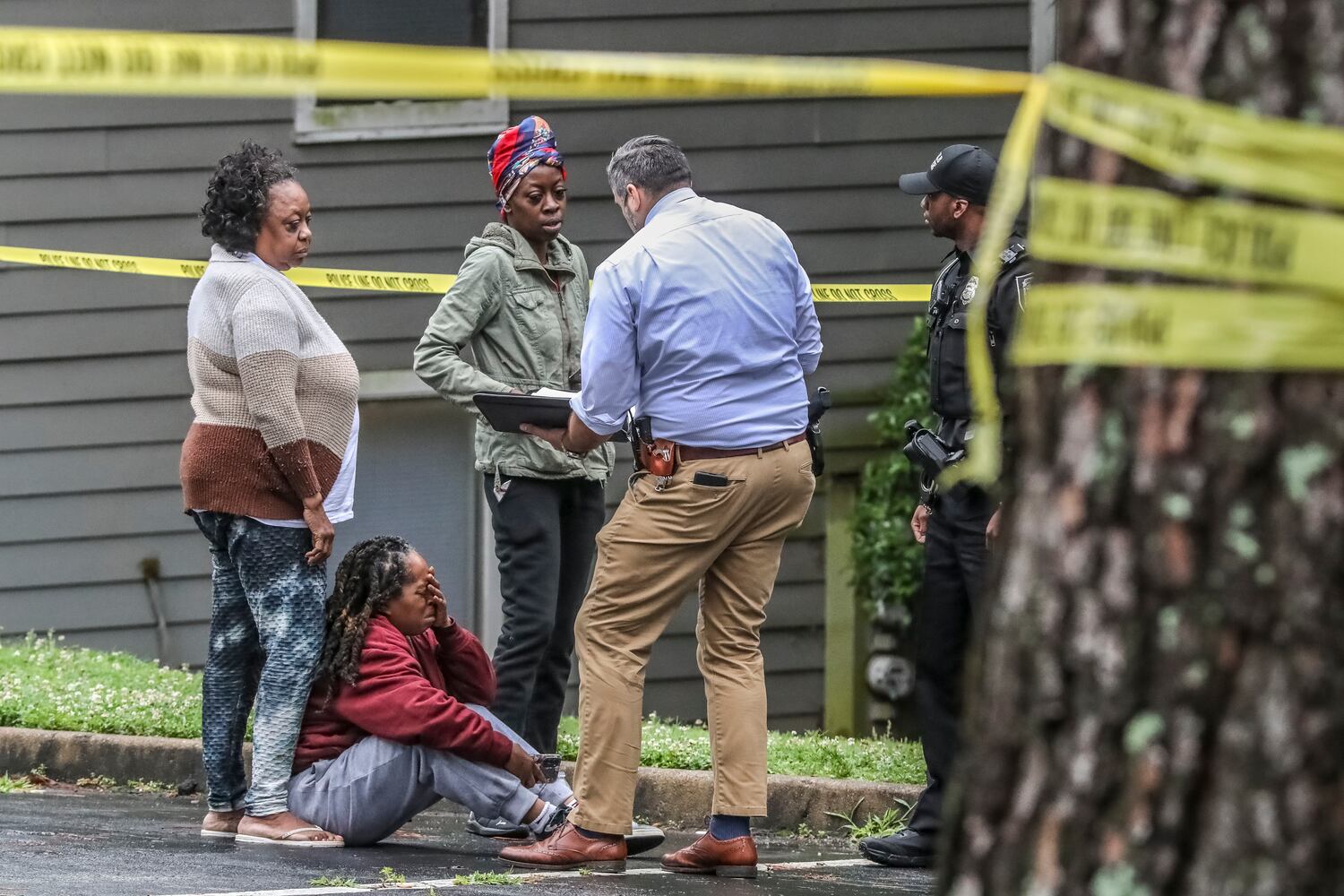 DeKalb County police were on the scene investigating a death of a woman who was found in the parking lot of an apartment complex near Stone Mountain on Thursday morning, June 22, 2023.  People who knew the deceased victim were emotional after learning of the death from police at the scene. (John Spink / John.Spink@ajc.com)


