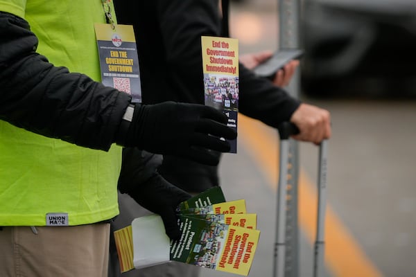 Members of the National Air Traffic Controllers Association union distributed leaflets about the shutdown’s effects at nearly two dozen airports to raise awareness, including Hartsfield-Jackson Atlanta International Airport on Tuesday Oct. 28, 2025. (Ben Hendren for the AJC)