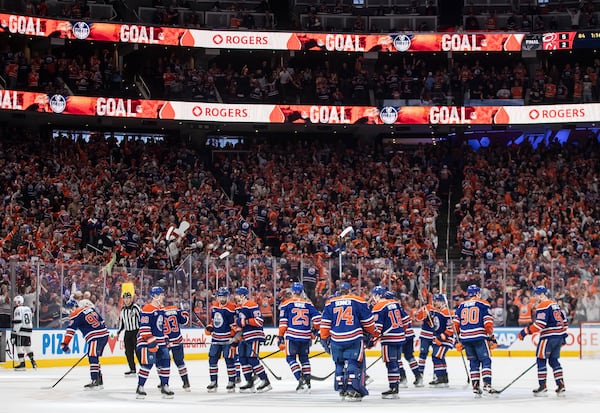 Edmonton Oilers players celebrate the win over the Los Angeles Kings during an overtime of an NHL playoff game in Edmonton on Sunday, April 27, 2025. (Jason Franson/The Canadian Press via AP)