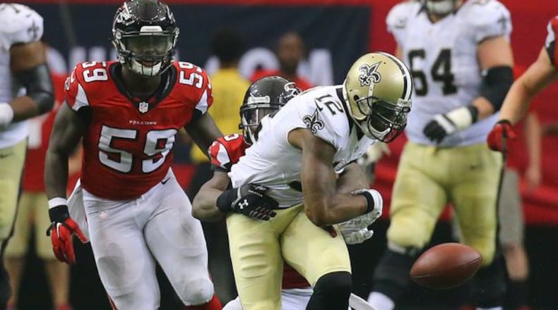 Falcons safety William Moore hits Saints wide receiver Marques Colston causing a fumble recovered by the Falcons in overtime in their NFL football game on Sunday, Sept. 7, 2014, in Atlanta. Falcons linebacker Joplo Bartu (left) recovered the fumble. The Falcons went on to kick a field goal to win the game 37-34. Moore could be back to face Cleveland on Nov. 23. (By Curtis Compton)