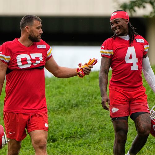 Kansas City Chiefs tight end Travis Kelce (87), and wide receiver Rashee Rice (4) walk to NFL football training camp Friday, July 31, 2026, in St. Joseph, Mo. (AP Photo/Charlie Riedel)