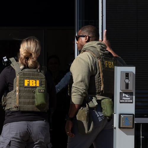 FBI agents enter the Fulton County Election Hub and Operation Center in Union City on Wednesday, Jan. 28, 2026, as the FBI conducts a raid. (Arvin Temkar/AJC)