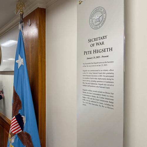 FILE - Workers remove sign lettering at the Pentagon after President Donald Trump signed an executive order aiming to rename the Department of Defense the Department of War in Washington, Sept. 5, 2025. (AP Photo/Mike Pesoli, File)