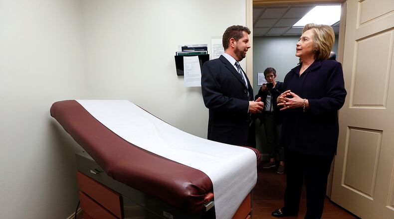 In this May 2, 2016 file photo, Dr. Christopher Beckett, CEO of Williamson Health and Wellness Center, left, tours an exam room of the facility with Democratic presidential candidate Hillary Clinton in Williamson, W. Va. With the Obama administration counting down its final year, many Democrats are finding less to like about the president’s health care law, unsure about its place among their party’s achievements. Sen. Bernie Sanders’ call for “Medicare for all” seems to have rekindled aspirations for bigger changes beyond “Obamacare.” That poses a challenge for Clinton, who’s argued that the health care law is working and the nation needs to build on it, not start over.