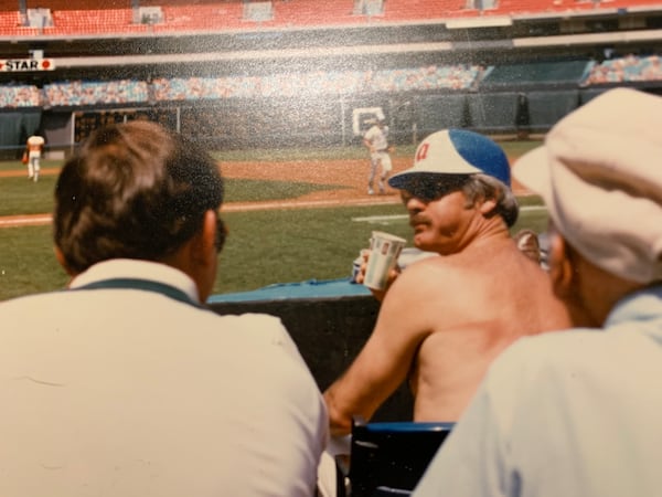 Ted Turner sits behind the Braves dugout during a game in the early 1980s.