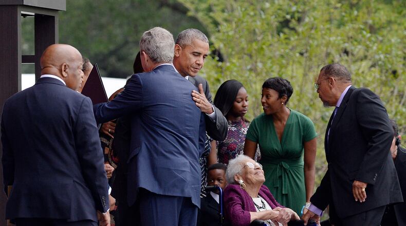 President Obama hugs former President George W. Bush as Rep. John Lewis, left, looks on during the opening ceremony of the Smithsonian National Museum of African American History and Culture on Saturday, Sept. 24, 2016, in Washington, D.C. (Olivier Douliery/Abaca Press/TNS)