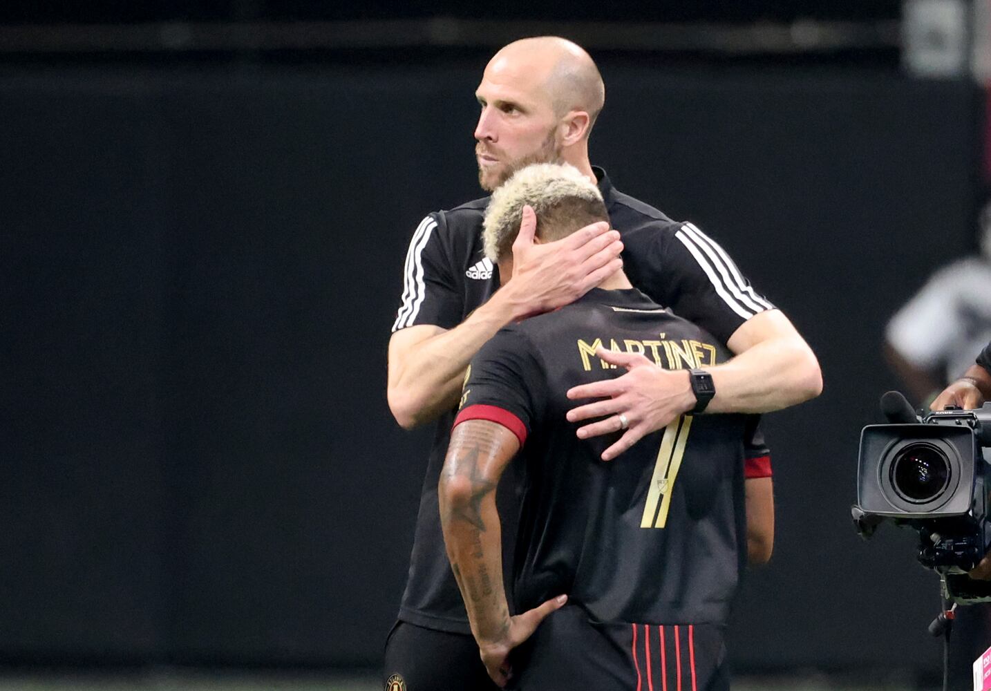 Atlanta United interim coach Rob Valentino consoles forward Josef Martinez (7) after their 1-0 loss to the Columbus Crew at Mercedes-Benz Stadium Saturday, July 24, 2021 in Atlanta. JASON GETZ FOR THE ATLANTA JOURNAL-CONSTITUTION