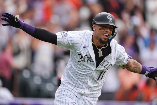 Former Braves shortstop Orlando Arcia celebrates his two-RBI walk-off hit for the Rockies on Thursday.