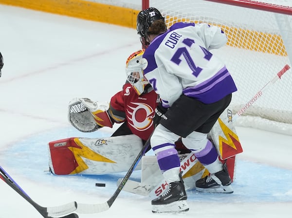 Minnesota Frost forward Britta Curl-Salemme (77) scores on Ottawa Charge goalie Gwyneth Philips (33) during the third period of a PWHL hockey final game, Thursday, May 22, 2025, in Ottawa. (Adrian Wyld/The Canadian Press via AP)