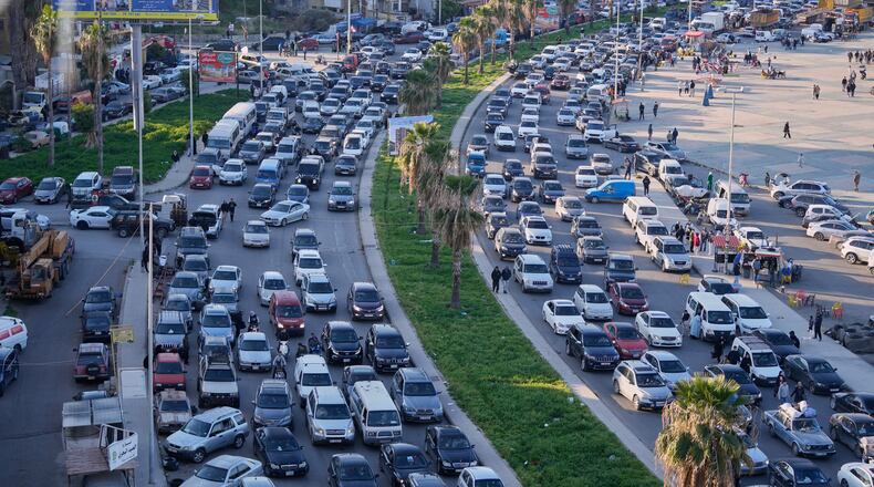 FILE - Displaced people fleeing Israeli strikes in southern Lebanon sit in traffic at a highway that links to Beirut, in the southern port city of Sidon, Monday, March 2, 2026. (AP Photo/Mohammed Zaatari, File)