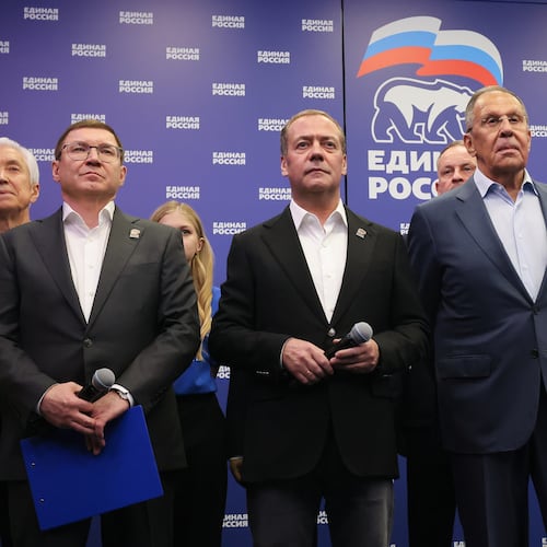 Russian Security Council Deputy Chairman and the head of the United Russia party Dmitry Medvedev, center, and Russian Foreign Minister Sergey Lavrov, center right, stand with other party members as they watch preliminary voting results for Russian parliamentary elections at the United Russia's headquarters in Moscow, Russia, Sunday, Sept. 20, 2026. (Ekaterina Shtukina, Sputnik, Kremlin Pool Photo via AP)