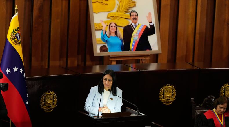 Venezuelan acting President Delcy Rodriguez speaks under a framed image of former President Nicolas Maduro and his wife Cilia Flores, during a ceremony marking the opening of the new judicial year at the Supreme Tribunal of Justice in Caracas, Venezuela, Friday, Jan. 30, 2026. (AP Photo/Ariana Cubillos)