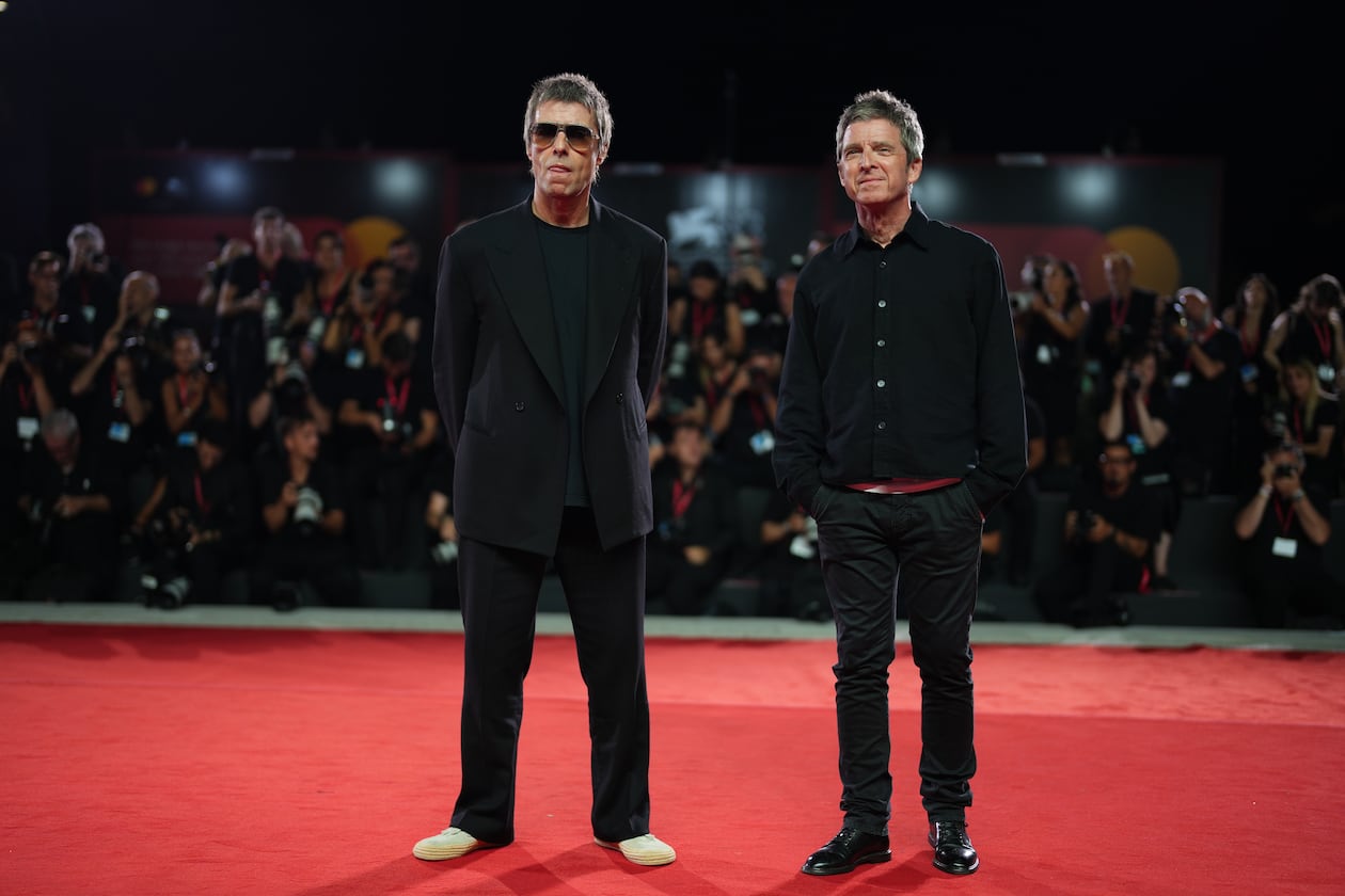 Liam Gallagher, left, and Noel Gallagher pose for photographers at the red carpet for the film 'Oasis: Don't Look Back In Anger' during the 83rd edition of the Venice Film Festival in Venice, Italy, on Saturday, Sept. 5, 2026. (Photo by Scott A Garfitt/Invision/AP)