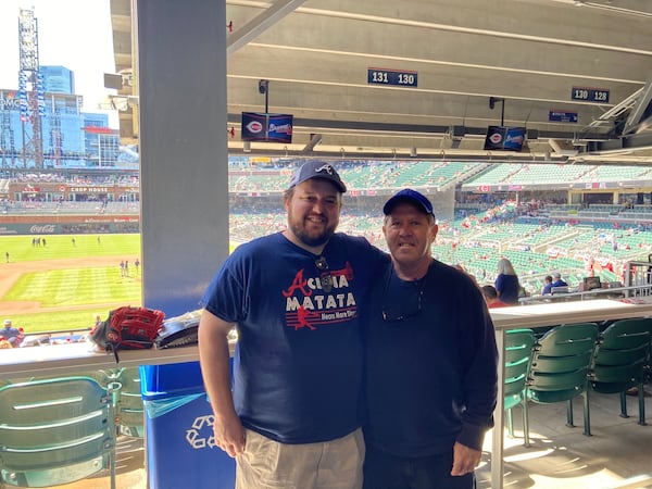 Carder England, left, with his dad David, loved the Braves. He also spent time as a professional poker player. (Courtesy of David England)