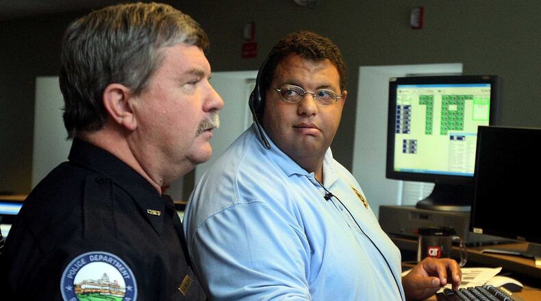 Roswell Police Chief Edwin Williams chats with Communications Officer Chad Jenkins in the Roswell 911 Center in August 2010.