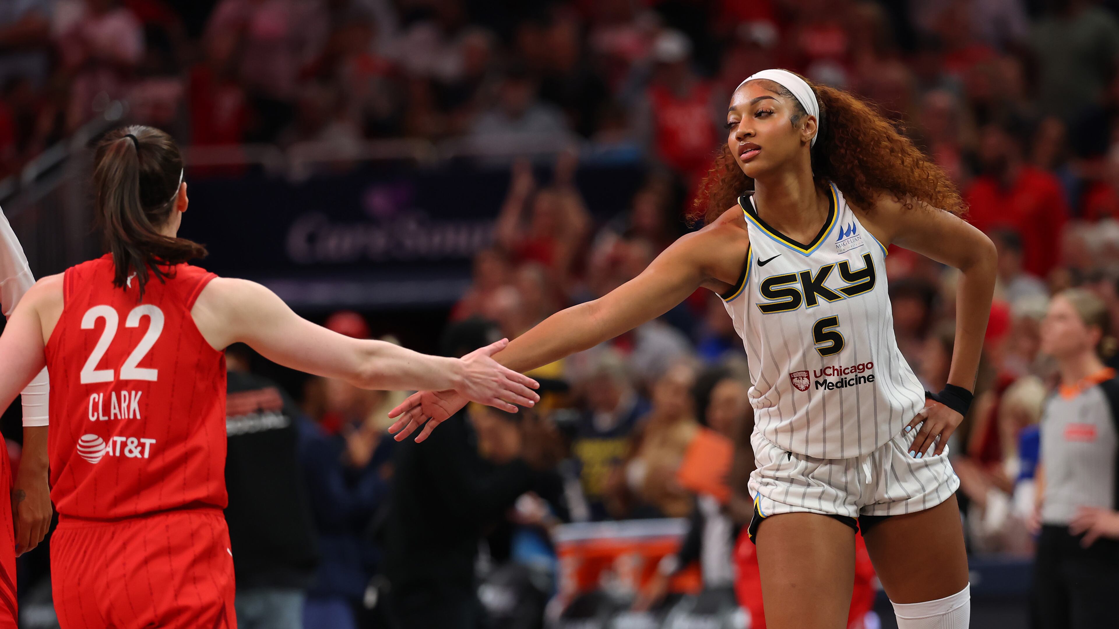 Angel Reese (5) of the Chicago Sky and Caitlin Clark (22) of the Indiana Fever meet at mid court prior to tipoff for the Fever's home opener, May 17, 2025, in Indianapolis. (Gregory Shamus/Getty Images/TNS)