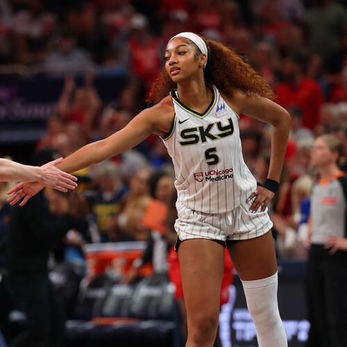 Angel Reese (5) of the Chicago Sky and Caitlin Clark (22) of the Indiana Fever meet at mid court prior to tipoff for the Fever's home opener, May 17, 2025, in Indianapolis. (Gregory Shamus/Getty Images/TNS)