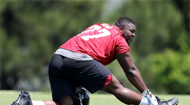 Offensive tackle Matt Gono stretches for the second day of Falcons rookie-mini-camp on Saturday, May 12, 2018, in Flowery Branch.